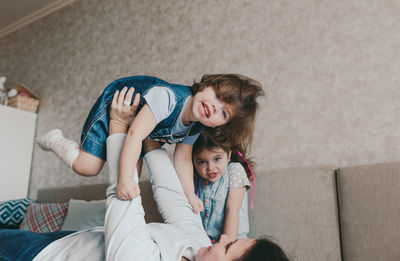 Full length of mother and girl at home