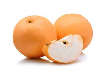 Close-up of pears against white background