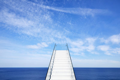 Sailboat on sea against blue sky