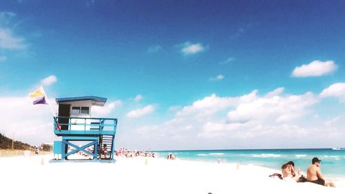 People on beach against sky