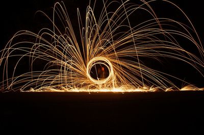 Low angle view of illuminated firework display at night