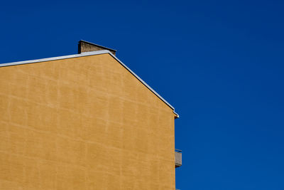 Low angle view of building against clear blue sky
