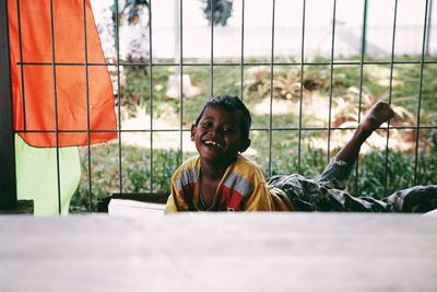 Portrait of smiling boy by window