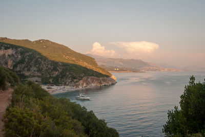 Scenic view of sea and mountains against sky