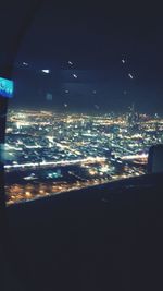 Aerial view of city lit up at night