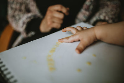 Child painting with finger