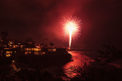 Firework display in city at night