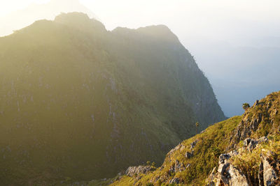 Natural landscape of green mountain range with cloudy mist sky