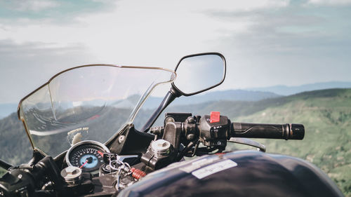 Close-up of bicycle on road against sky
