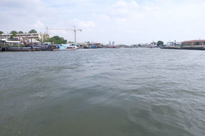 Scenic view of river against cloudy sky