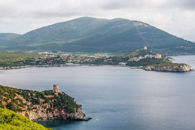 Scenic view of sea and mountains against sky