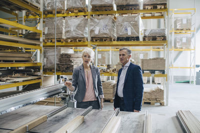 Business people analyzing wooden planks at industry