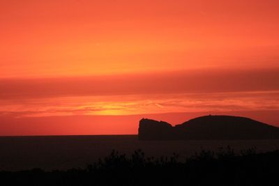 Scenic view of silhouette landscape against romantic sky at sunset