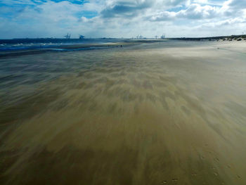 Scenic view of sea against cloudy sky