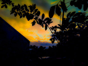 Low angle view of silhouette trees against sky at sunset