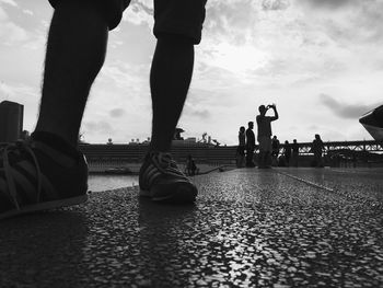 Silhouette of woman against cloudy sky