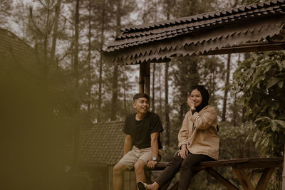 Young couple sitting outdoors