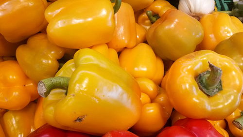 Full frame shot of yellow bell peppers for sale at market stall