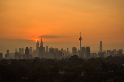 View of buildings in city during sunset