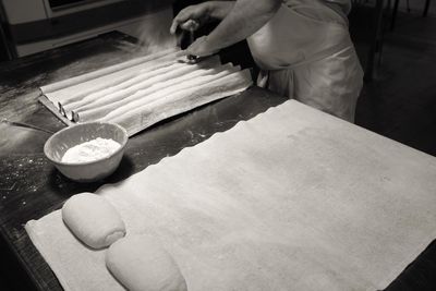 Cropped image of baker making bread at bakery