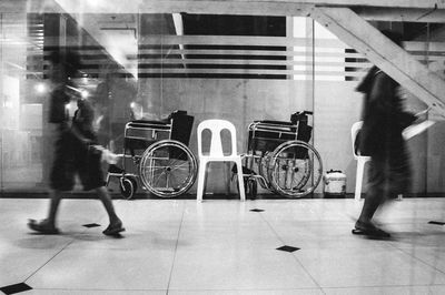 Low section of people standing on tiled floor in city