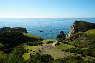 High angle view of rocks in sea against clear sky