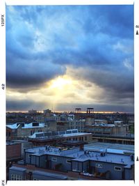 View of cityscape against cloudy sky