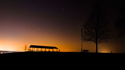 Silhouette built structure against sky at night