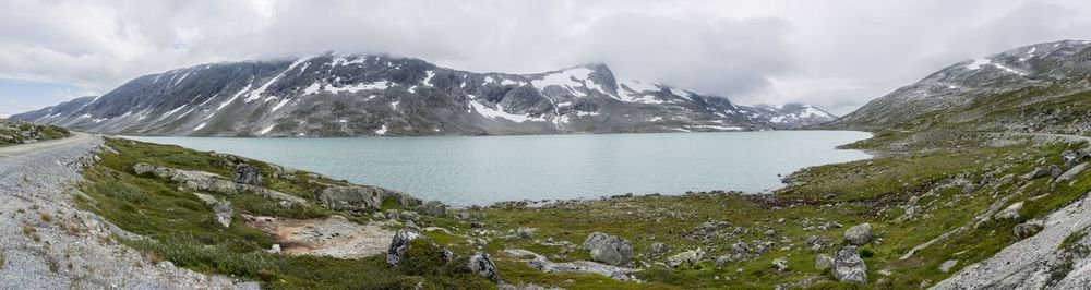 Scenic view of mountains against cloudy sky