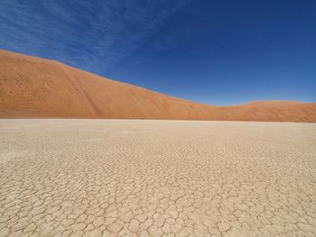 Scenic view of desert against clear blue sky