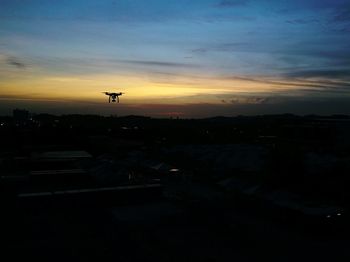 Silhouette landscape against sky during sunset