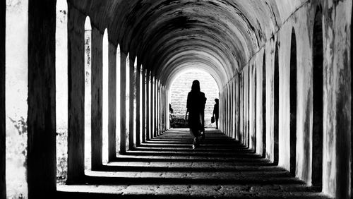 Rear view of man walking in corridor