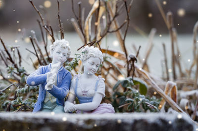 Close-up of angel statue against plants