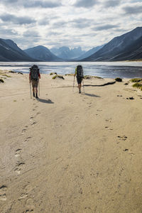 Backpackers leave footprints in the sand in akshayak pass