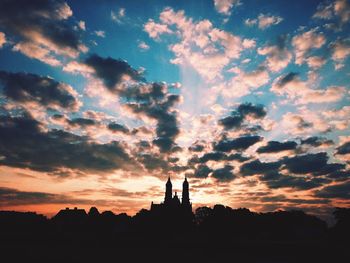 Silhouette of built structure against dramatic sky