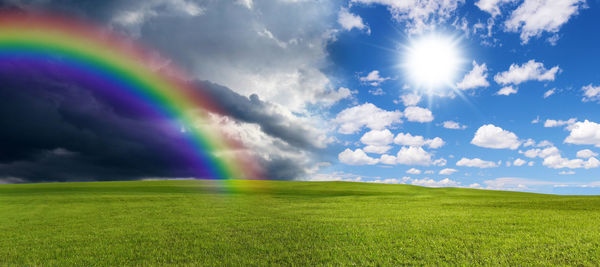 Scenic view of rainbow over field