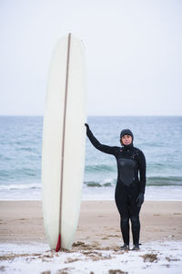 Young woman going winter surfing in snow