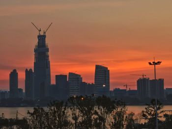 View of buildings in city during sunset