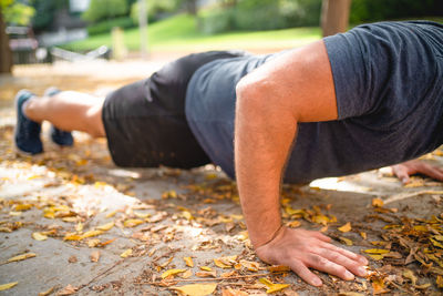 Midsection of man lying down during autumn