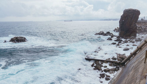 Scenic view of rocks in sea against sky