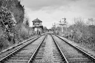 Railroad tracks by building against sky