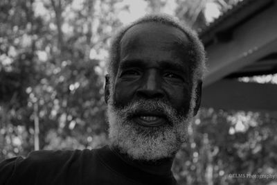 Portrait of man against blurred trees