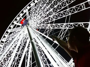 Low angle view of ferris wheel at night