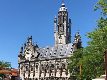 Low angle view of building against clear blue sky