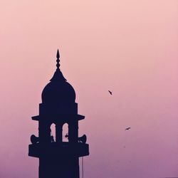 Low angle view of built structure at sunset