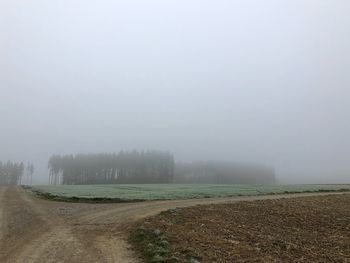 Scenic view of field against sky during winter