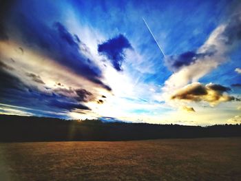 Scenic view of dramatic sky over land