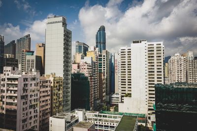 View of skyscrapers against cloudy sky