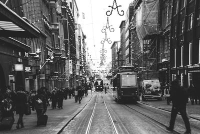 People on railroad tracks in city
