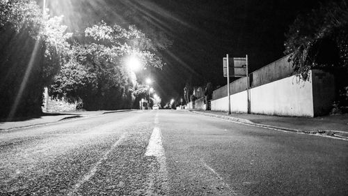 View of illuminated road at night